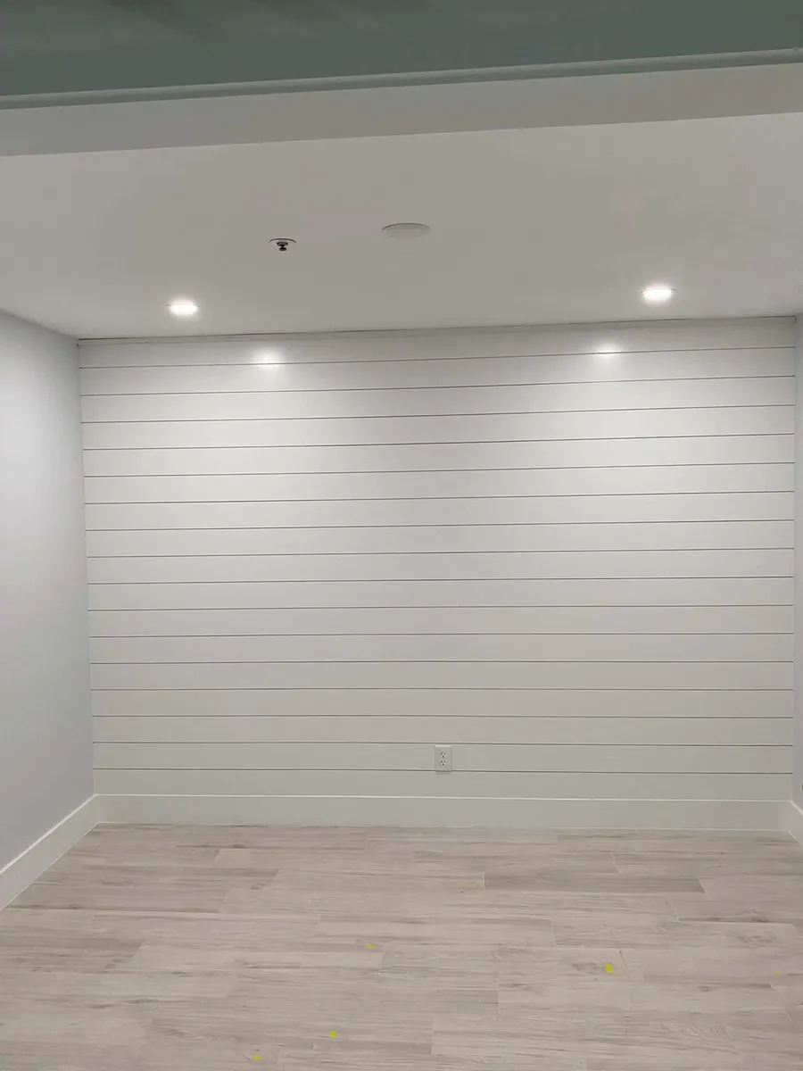 Full-width white shiplap wall