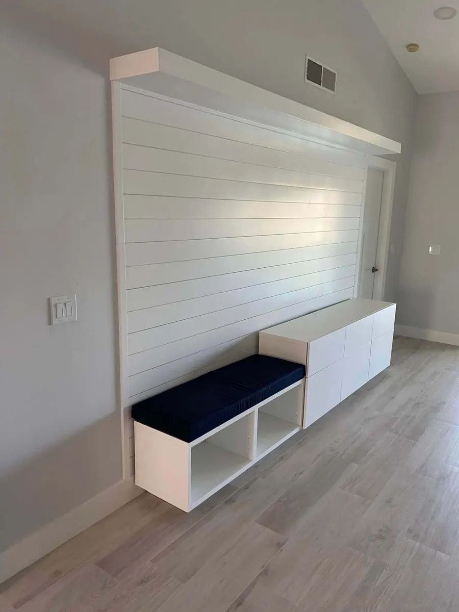 White shiplap wall with built-in bench seating