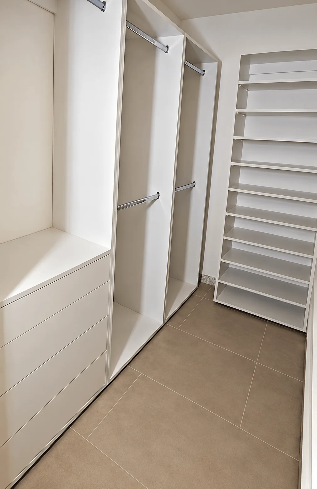 White custom closet with built-in shoe shelving