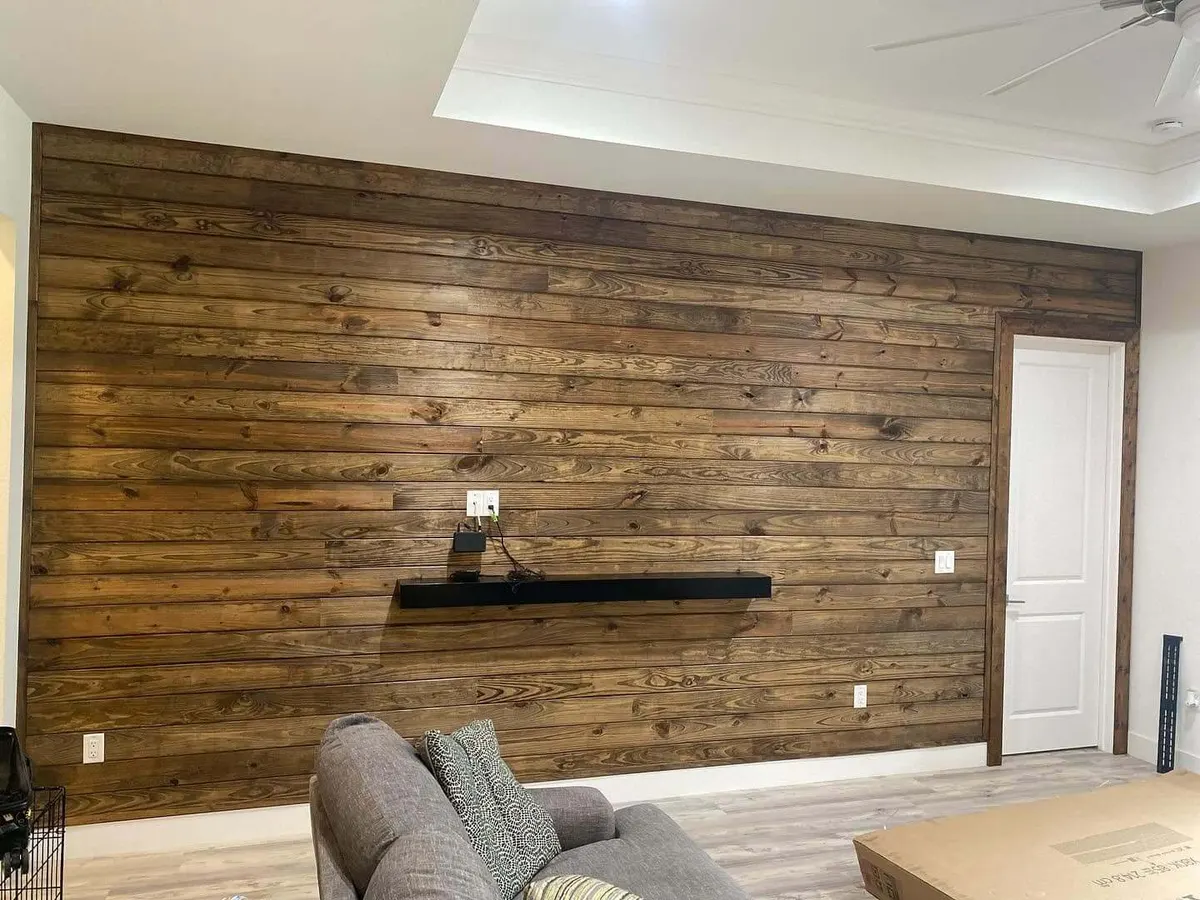 Rustic wood plank accent wall with floating shelf